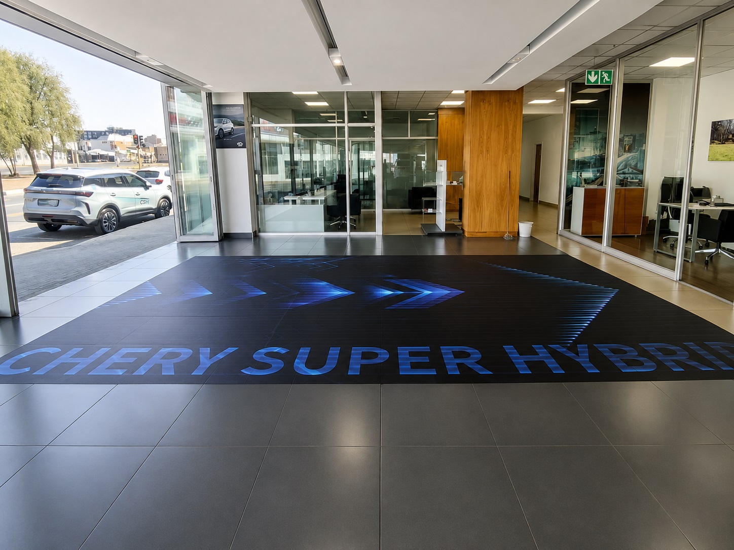 Large-format Chery Super Hybrid floor graphics installed inside a branded dealership environment by Dynamic Signs & Print.