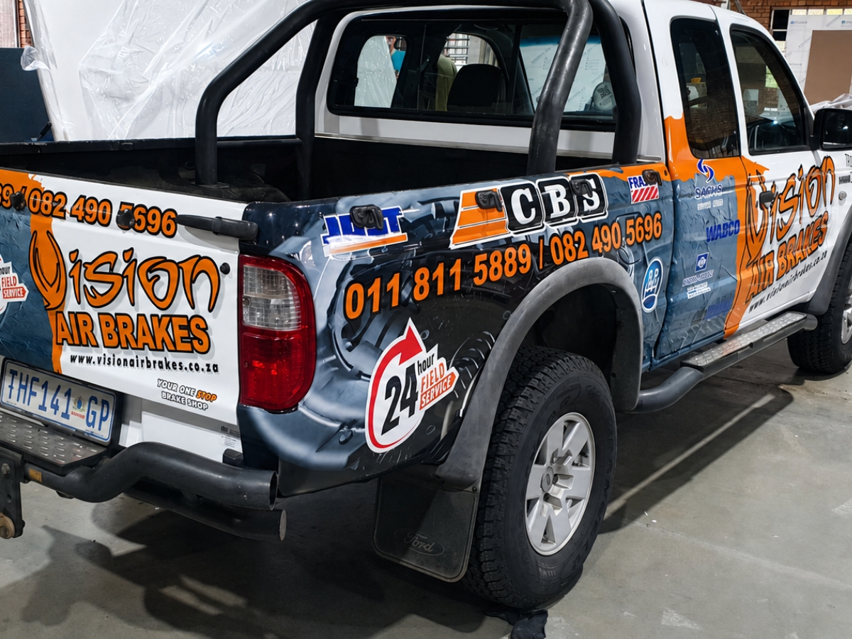Commercial bakkie with detailed printed vehicle branding and vinyl graphics