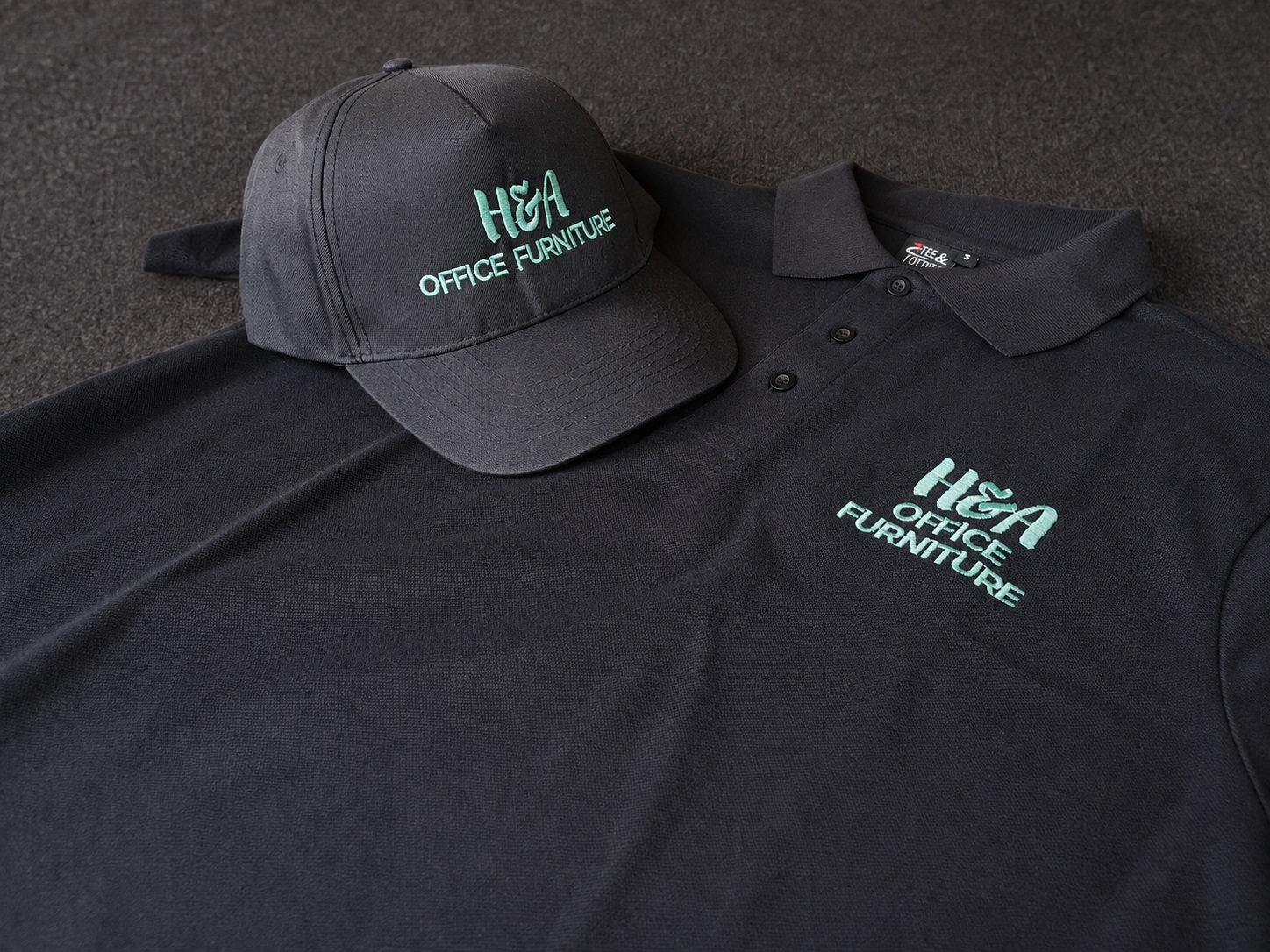 Branded cap and polo shirts with custom corporate embroidery produced by Dynamic Signs & Print