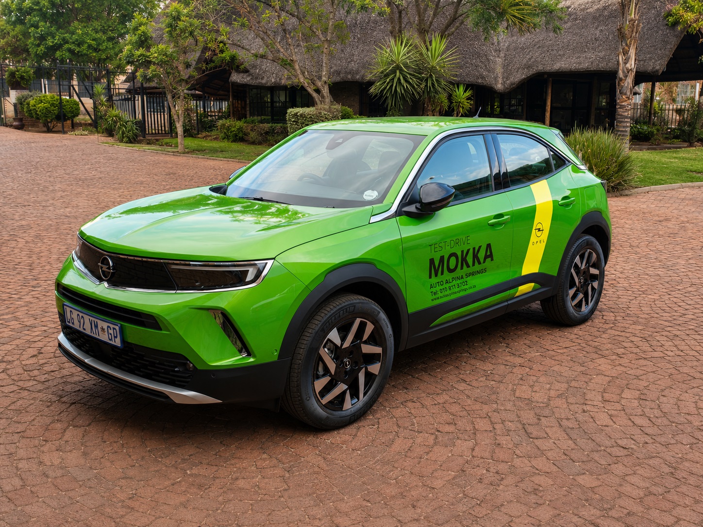 Green Opel Mokka with promotional vehicle graphics produced by Dynamic Signs & Print