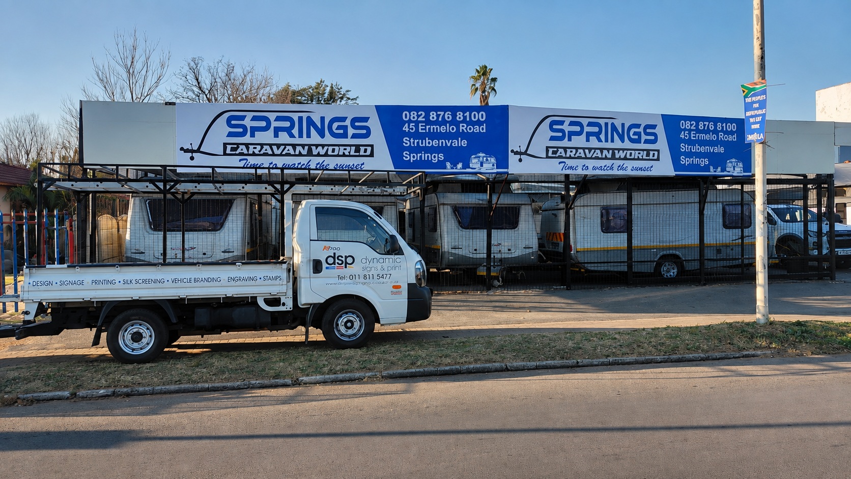 Springs Caravan World storefront signage with a DSP-branded production vehicle parked outside.