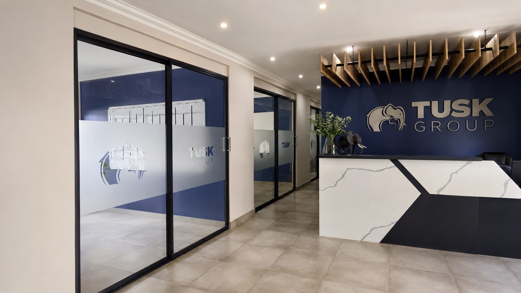 Tusk Group reception featuring dimensional wall signage and branded office glass installed by Dynamic Signs & Print.